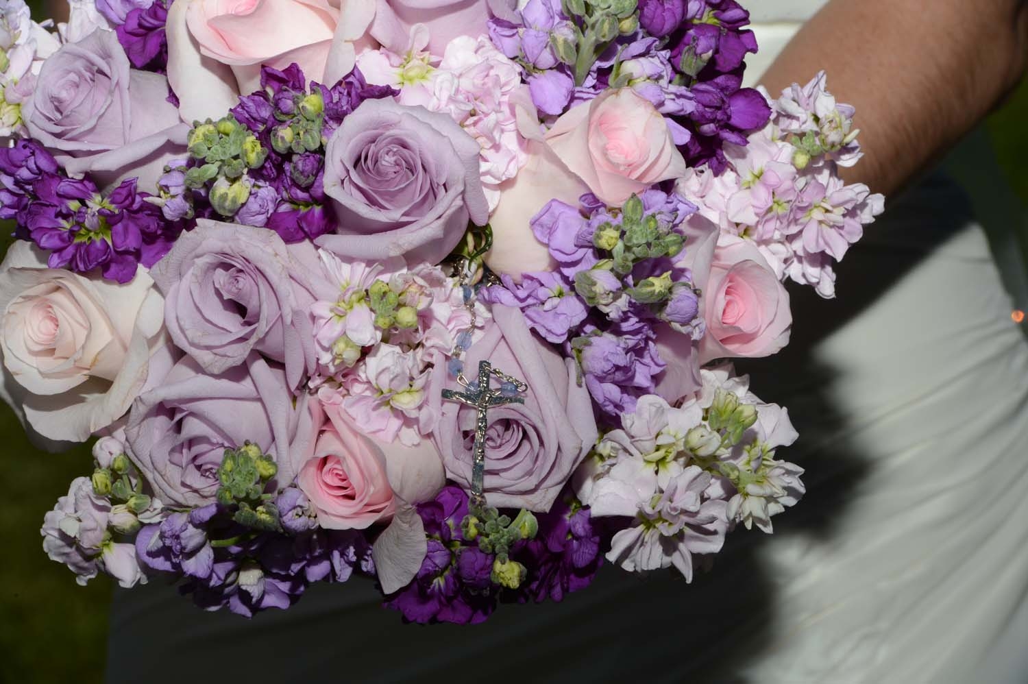 Bridal bouquet of pink and lavender roses with purple and lavender stock.